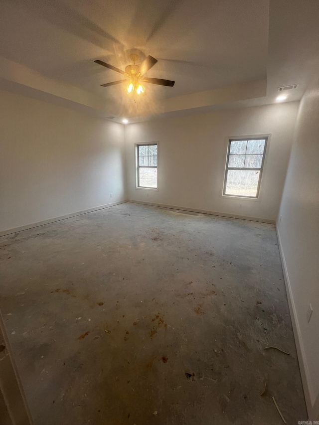 spare room with visible vents, baseboards, and a ceiling fan