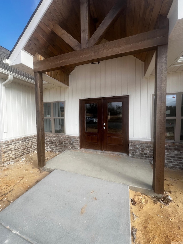 doorway to property with brick siding