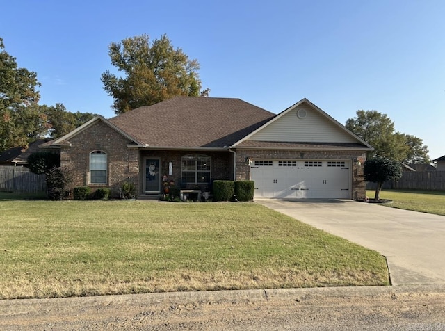 ranch-style house with fence, driveway, a front lawn, a garage, and brick siding