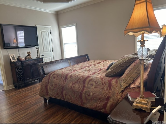 bedroom featuring crown molding and wood finished floors