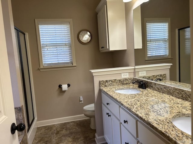 bathroom featuring a shower stall, a wealth of natural light, and a sink