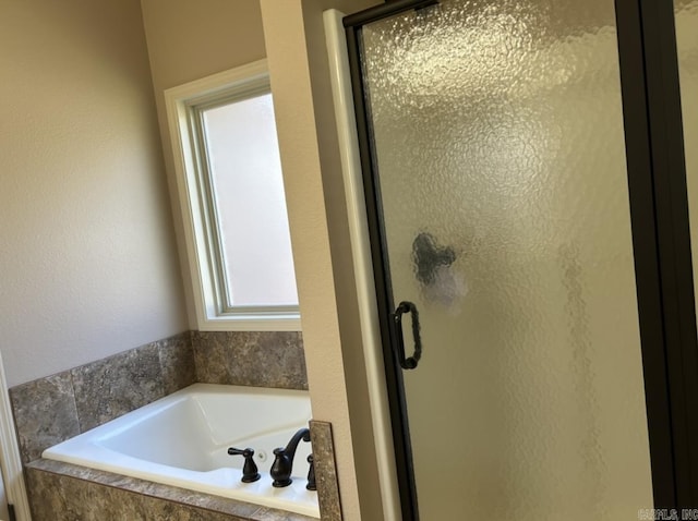 bathroom with a garden tub and a shower stall