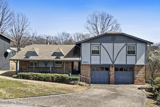 view of front of house featuring aphalt driveway, brick siding, and an attached garage