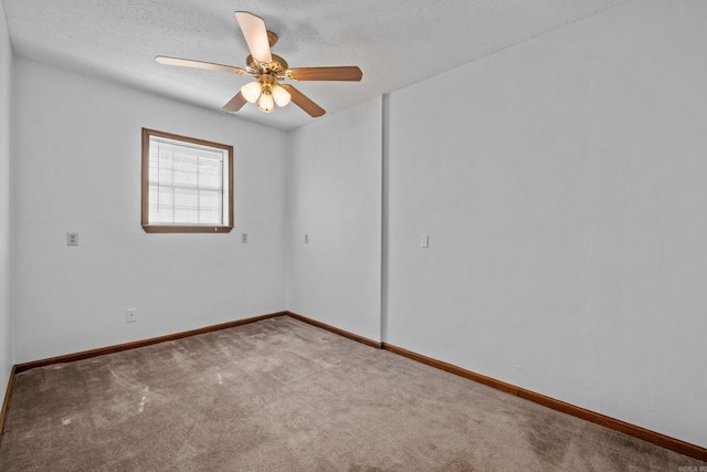 unfurnished room featuring a ceiling fan, carpet, baseboards, and a textured ceiling