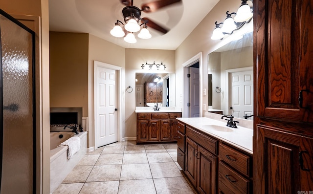 full bath with two vanities, ceiling fan, tile patterned flooring, a sink, and a bath