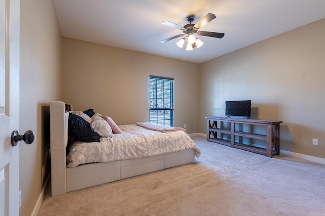 carpeted bedroom featuring ceiling fan and baseboards