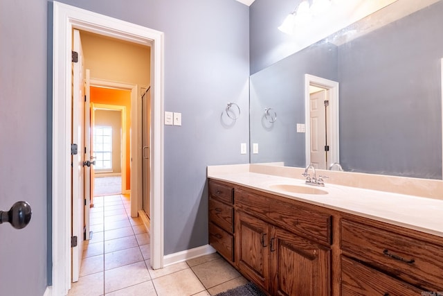 bathroom featuring tile patterned floors, vanity, and baseboards