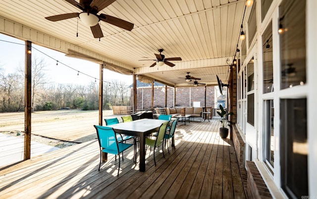 wooden deck featuring outdoor dining space, outdoor lounge area, and a ceiling fan