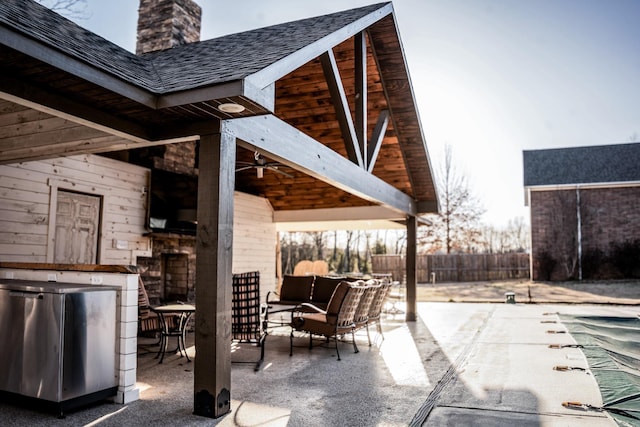 view of patio featuring a ceiling fan, an outdoor living space, and fence