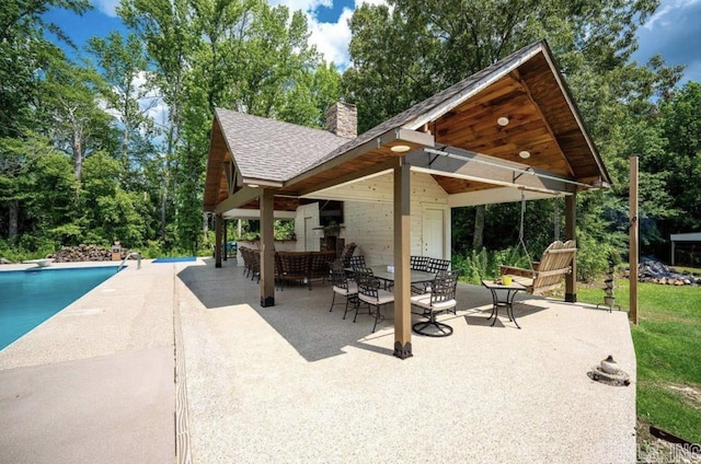 view of patio / terrace featuring outdoor dining space and an outdoor pool