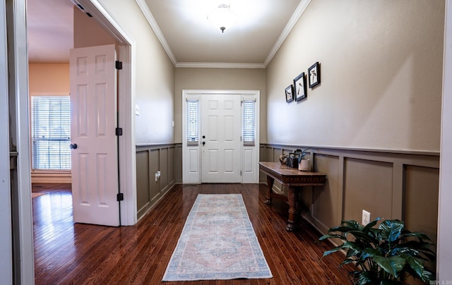 entryway featuring wainscoting, crown molding, and dark wood-type flooring