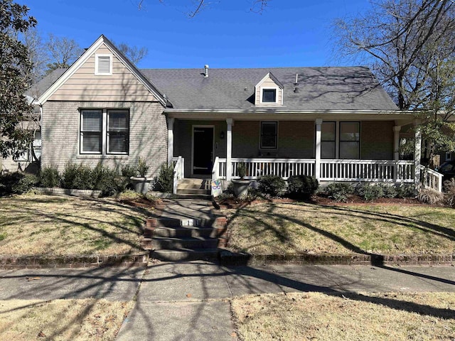 view of front of house with brick siding and covered porch