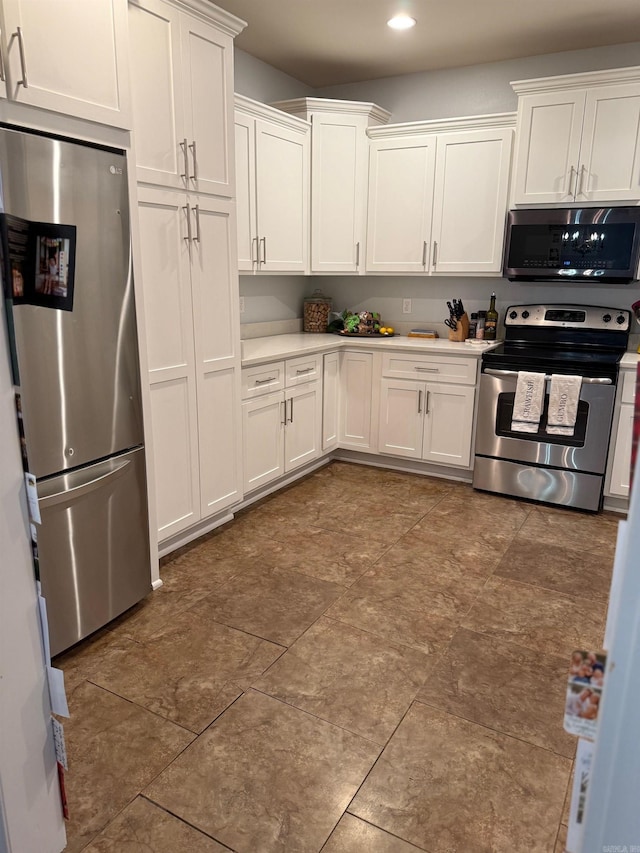 kitchen featuring light countertops, white cabinets, recessed lighting, and stainless steel appliances