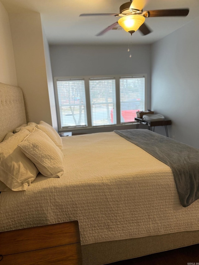 bedroom with multiple windows and ceiling fan