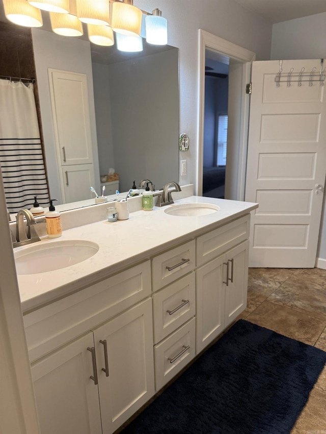 full bathroom featuring double vanity, a shower with curtain, and a sink