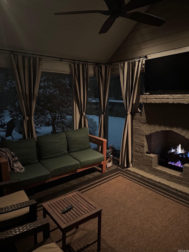 living area featuring carpet, a ceiling fan, and vaulted ceiling