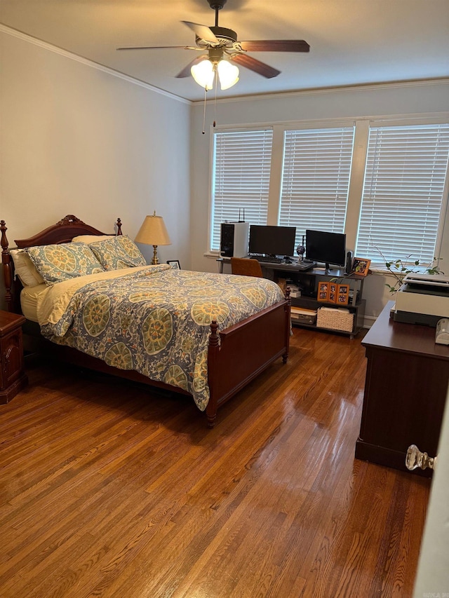 bedroom with crown molding, dark wood-style flooring, and ceiling fan