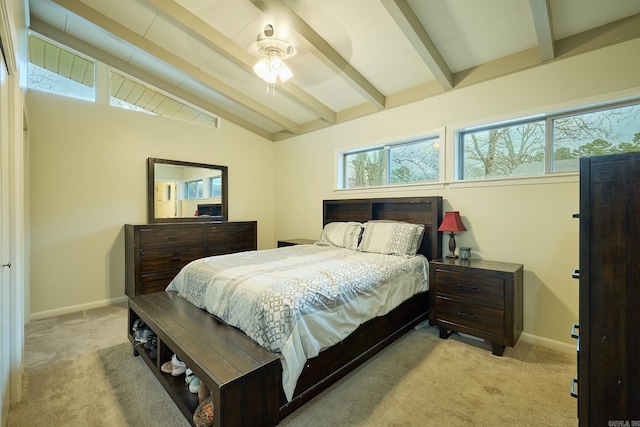 bedroom featuring multiple windows, baseboards, lofted ceiling with beams, and carpet