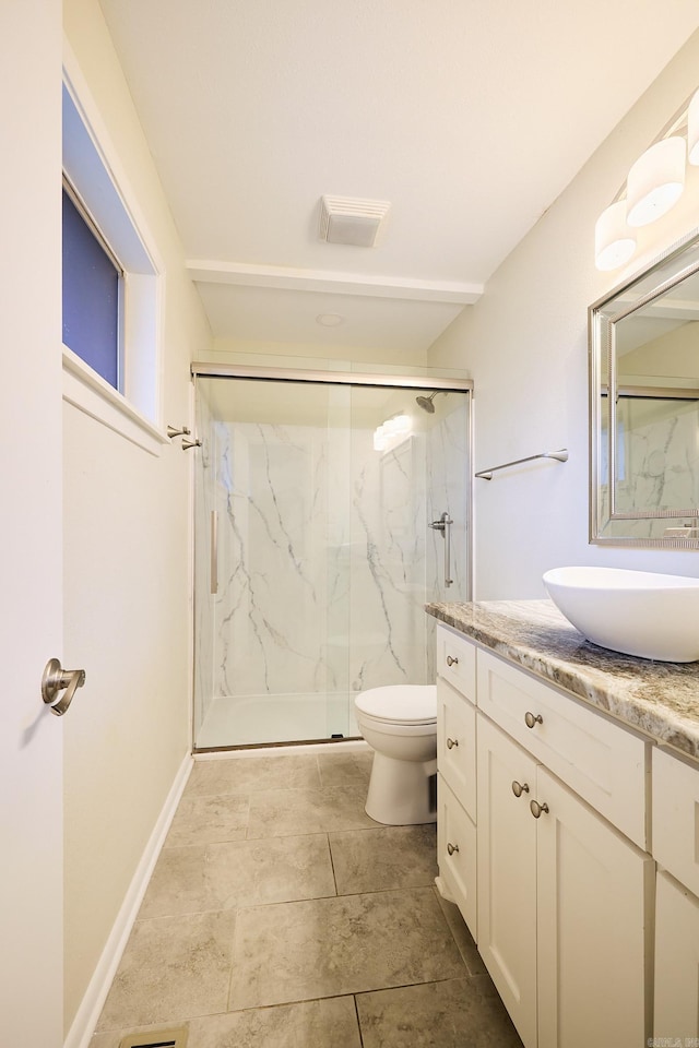 bathroom featuring a marble finish shower, visible vents, baseboards, toilet, and vanity