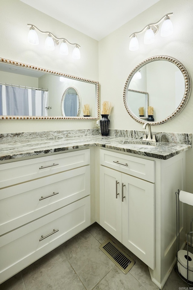 bathroom with tile patterned flooring, visible vents, and vanity