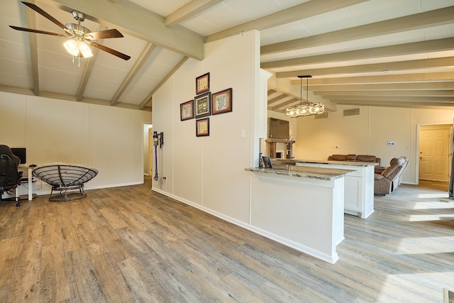 interior space featuring light stone counters, vaulted ceiling with beams, a ceiling fan, and light wood-style floors