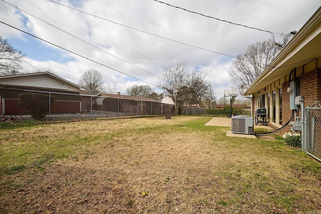 view of yard featuring central AC unit and a fenced backyard