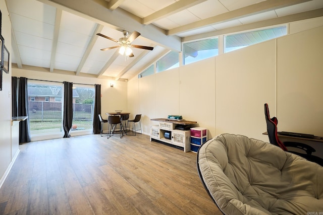 living area featuring lofted ceiling with beams, wood finished floors, and a ceiling fan