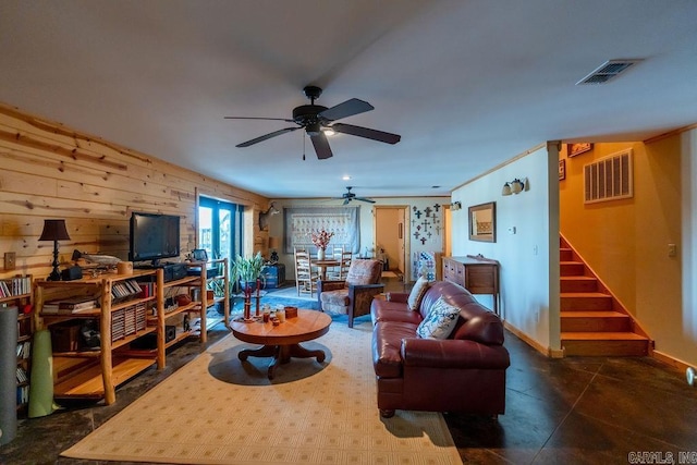 living room with visible vents, stairway, baseboards, and a ceiling fan