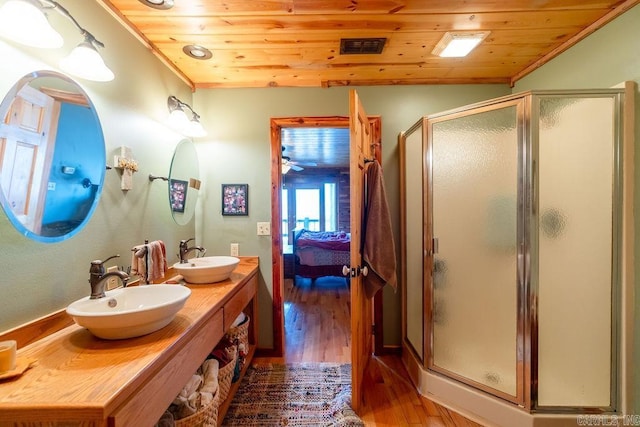 bathroom featuring a sink, wood ceiling, and ensuite bathroom