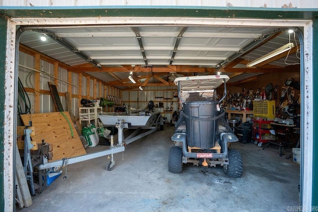 garage with a workshop area and metal wall