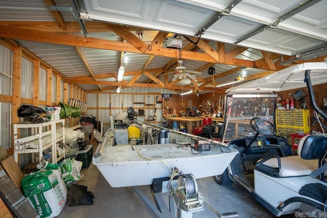 garage featuring a workshop area, a garage door opener, and metal wall