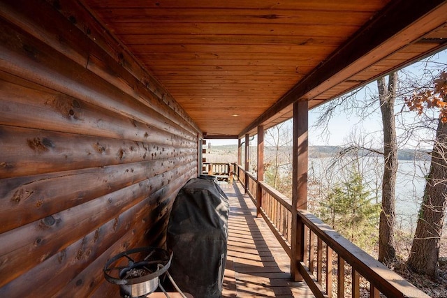 wooden terrace featuring a grill