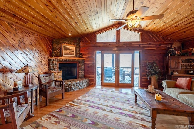 living room featuring ceiling fan, wood finished floors, wooden walls, and wooden ceiling