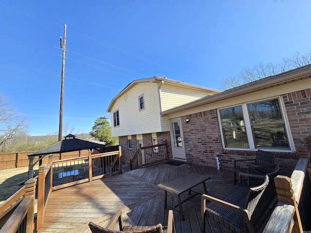 wooden deck with a gazebo and fence