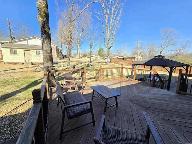 wooden terrace featuring a lawn, an outdoor structure, and fence