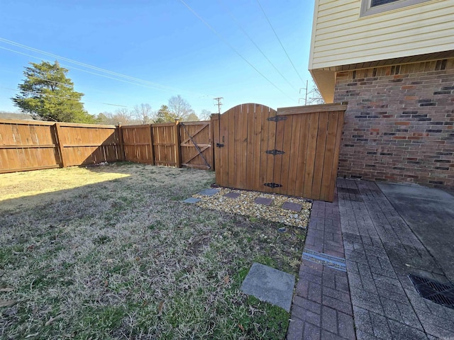 view of yard with fence and a gate