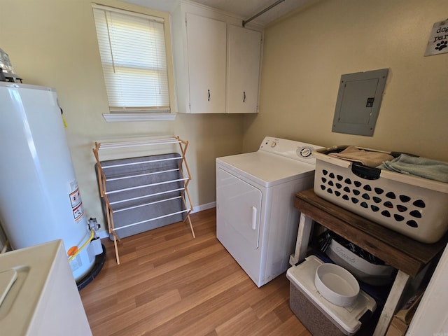 clothes washing area featuring washing machine and clothes dryer, gas water heater, electric panel, laundry area, and light wood-style floors