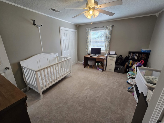 carpeted bedroom featuring visible vents, a textured ceiling, a closet, and ornamental molding