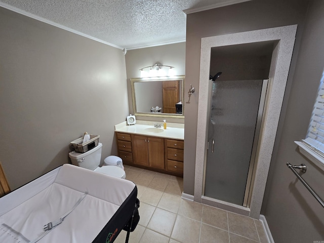 bathroom with vanity, a shower stall, a textured ceiling, and ornamental molding