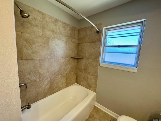 bathroom featuring bathing tub / shower combination, baseboards, and tile patterned floors