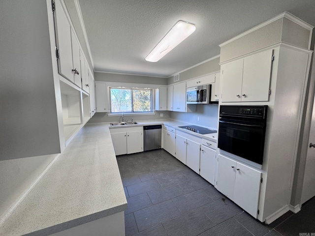 kitchen featuring black appliances, light countertops, white cabinets, a textured ceiling, and a sink