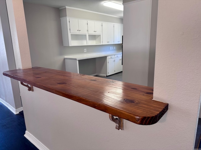 kitchen featuring white cabinetry, baseboards, and dark wood-style flooring