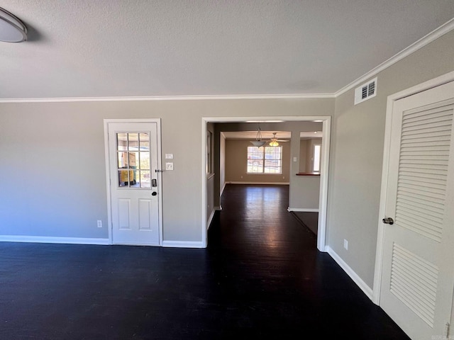 entrance foyer featuring visible vents, baseboards, dark wood-style floors, and ornamental molding