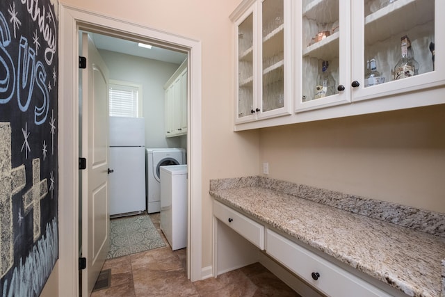 laundry room with cabinet space, visible vents, and washer / dryer