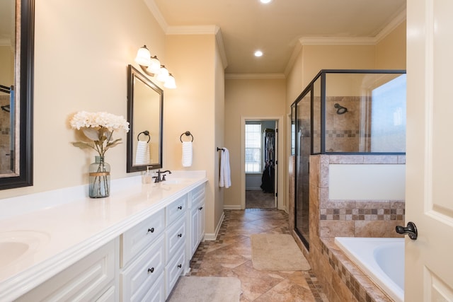 full bathroom featuring double vanity, tiled tub, a stall shower, a sink, and crown molding