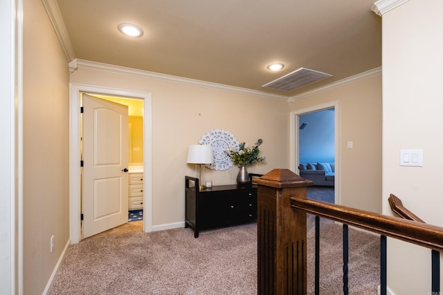 hall with visible vents, light carpet, baseboards, and crown molding