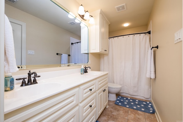 bathroom featuring tile patterned floors, visible vents, double vanity, and a sink