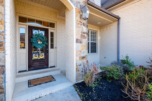 property entrance featuring brick siding