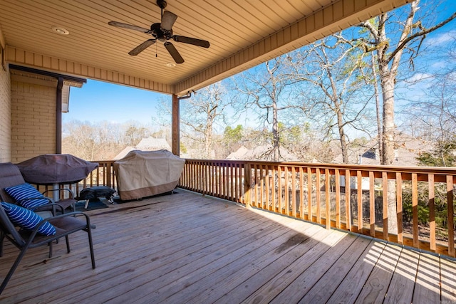 wooden terrace featuring ceiling fan and grilling area