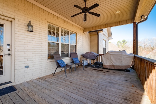 deck with grilling area and a ceiling fan